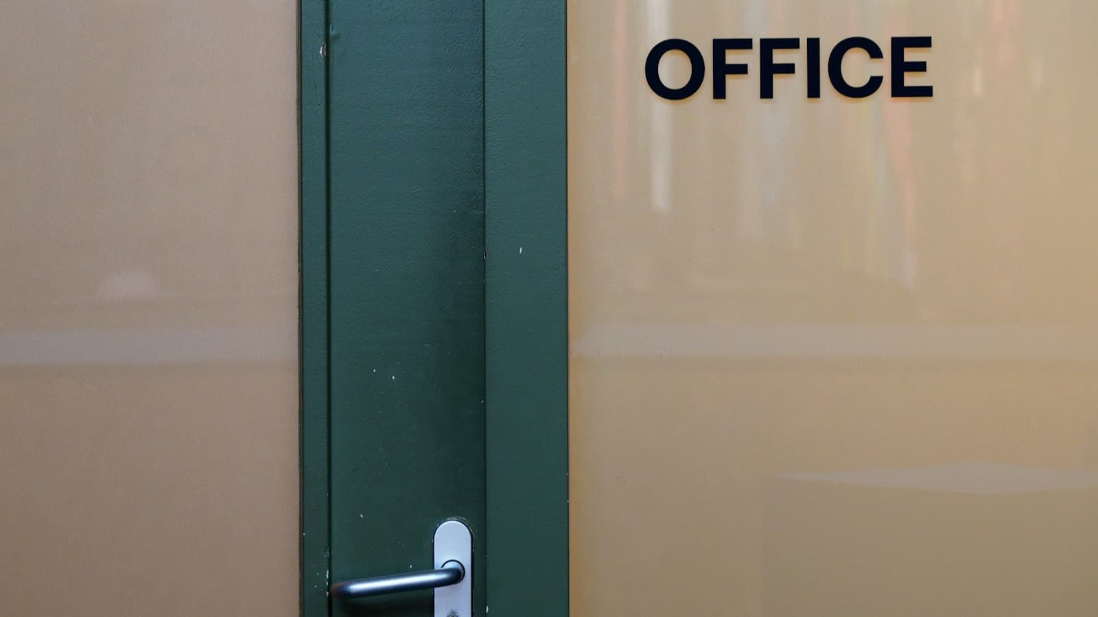 Locksmith servicing a commercial storefront door